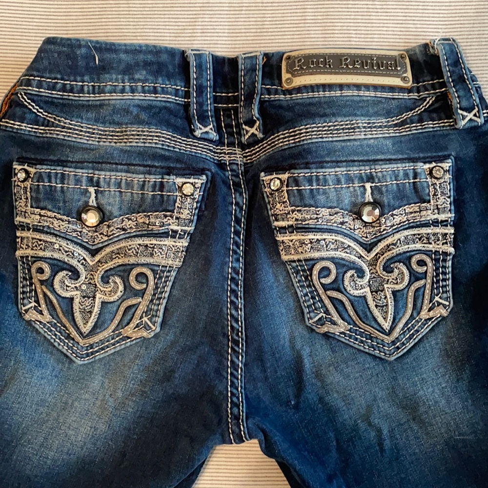 Rock Revivals mid rise boot cut jeans (size 27)